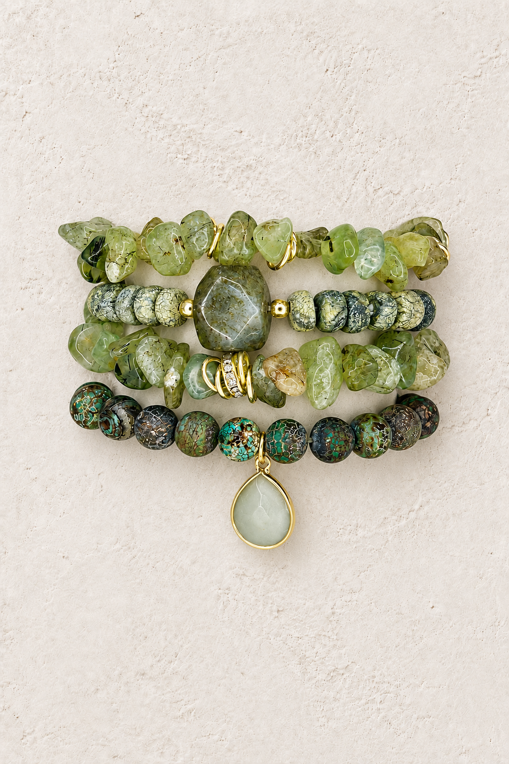 Moss Grove 4-piece elastic bracelet stack on warm textured background