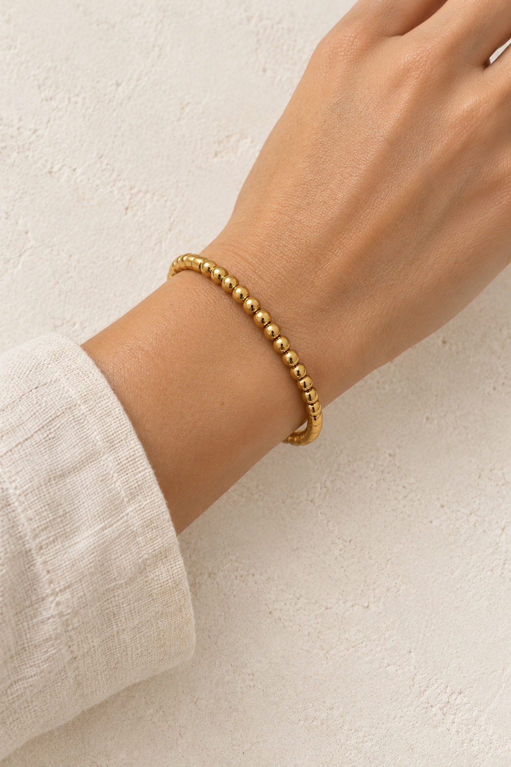 
                  
                    Model wearing Naya Gold Beaded Bangle
                  
                
