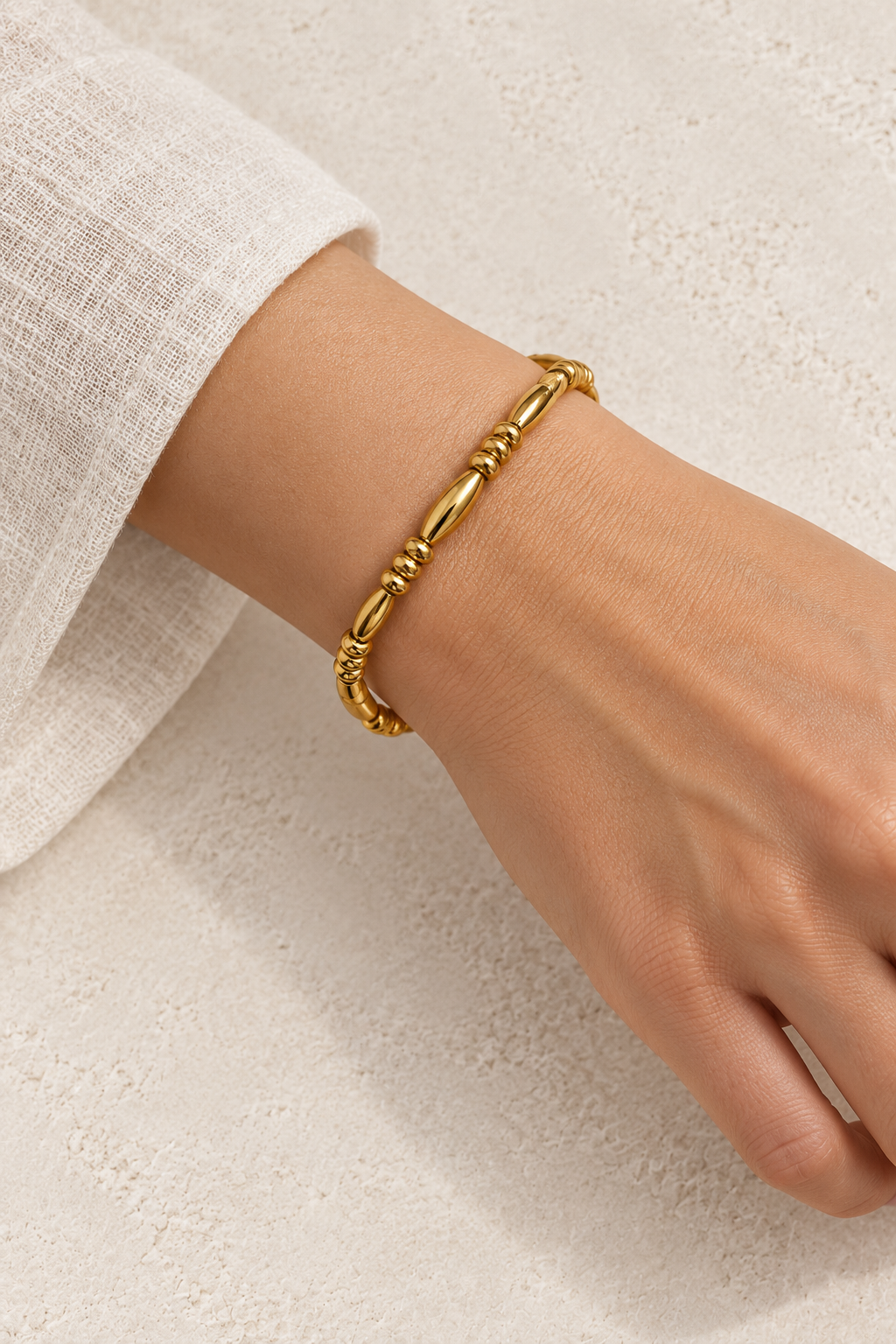 Model wearing Naya Gold Elongated Bead Bangle