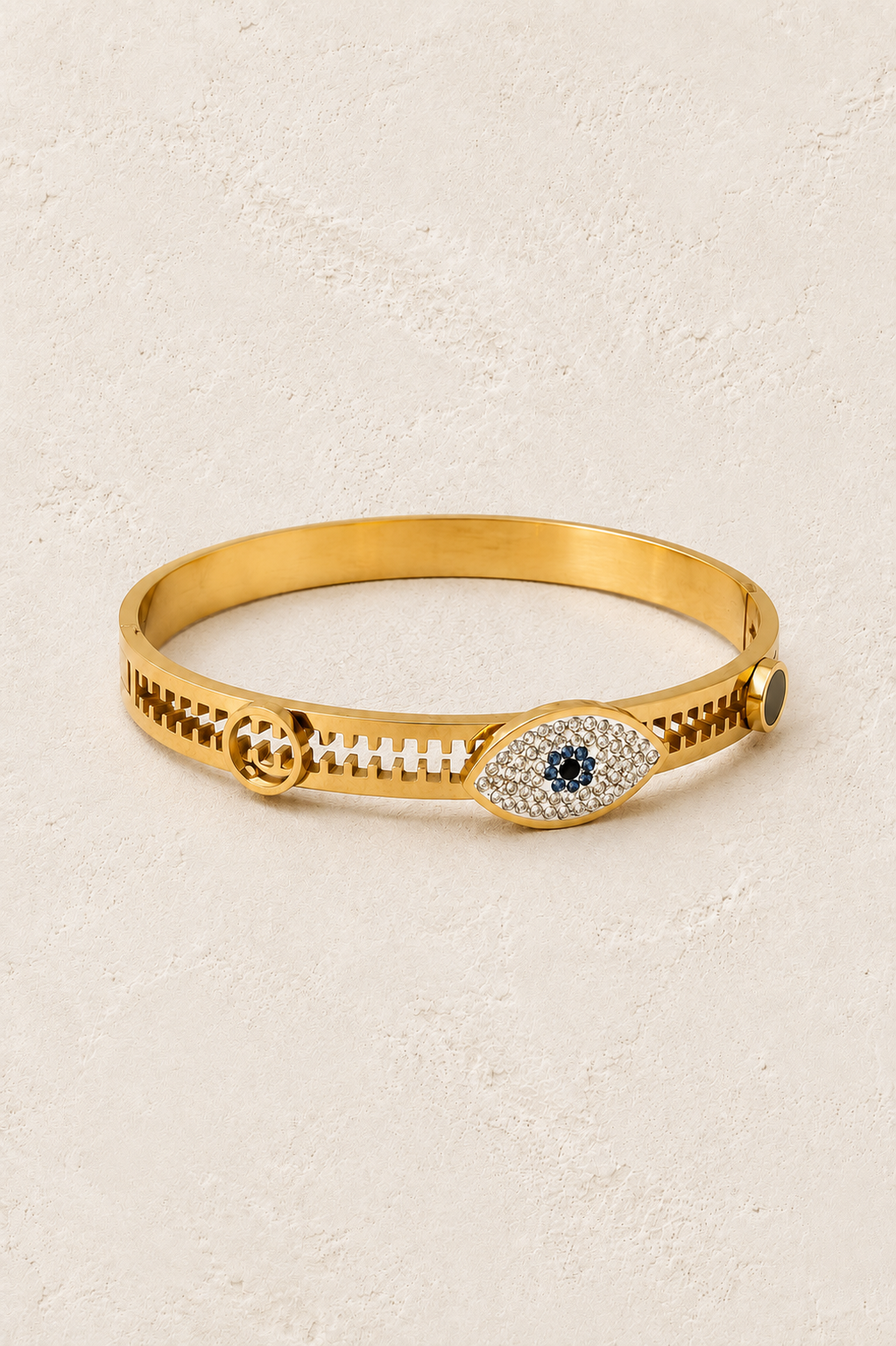 Nazari Evil Eye Gold Bangle on cream beige textured background