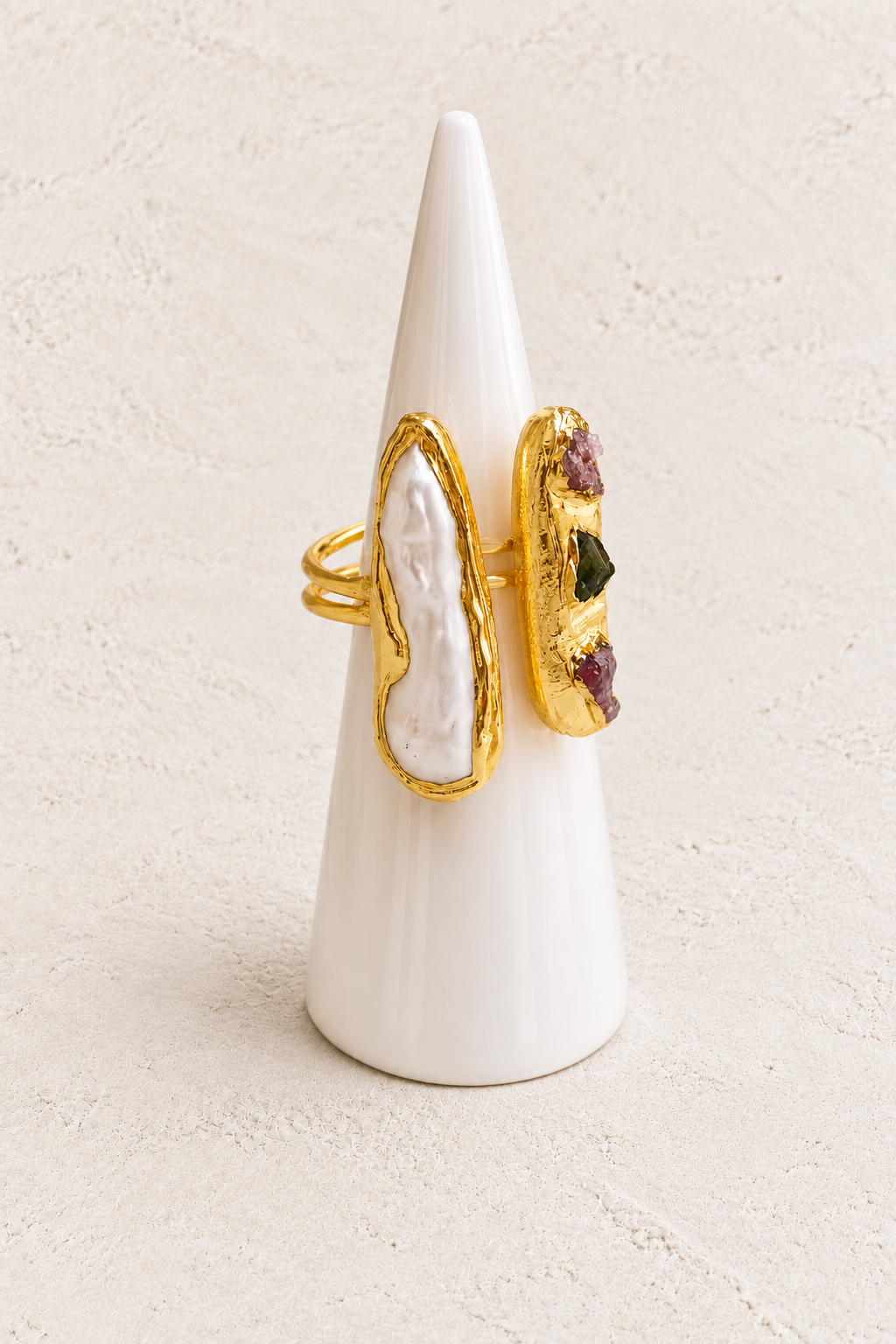 Nerelle Biwa Freshwater Pearl Ring on white cone against warm textured background