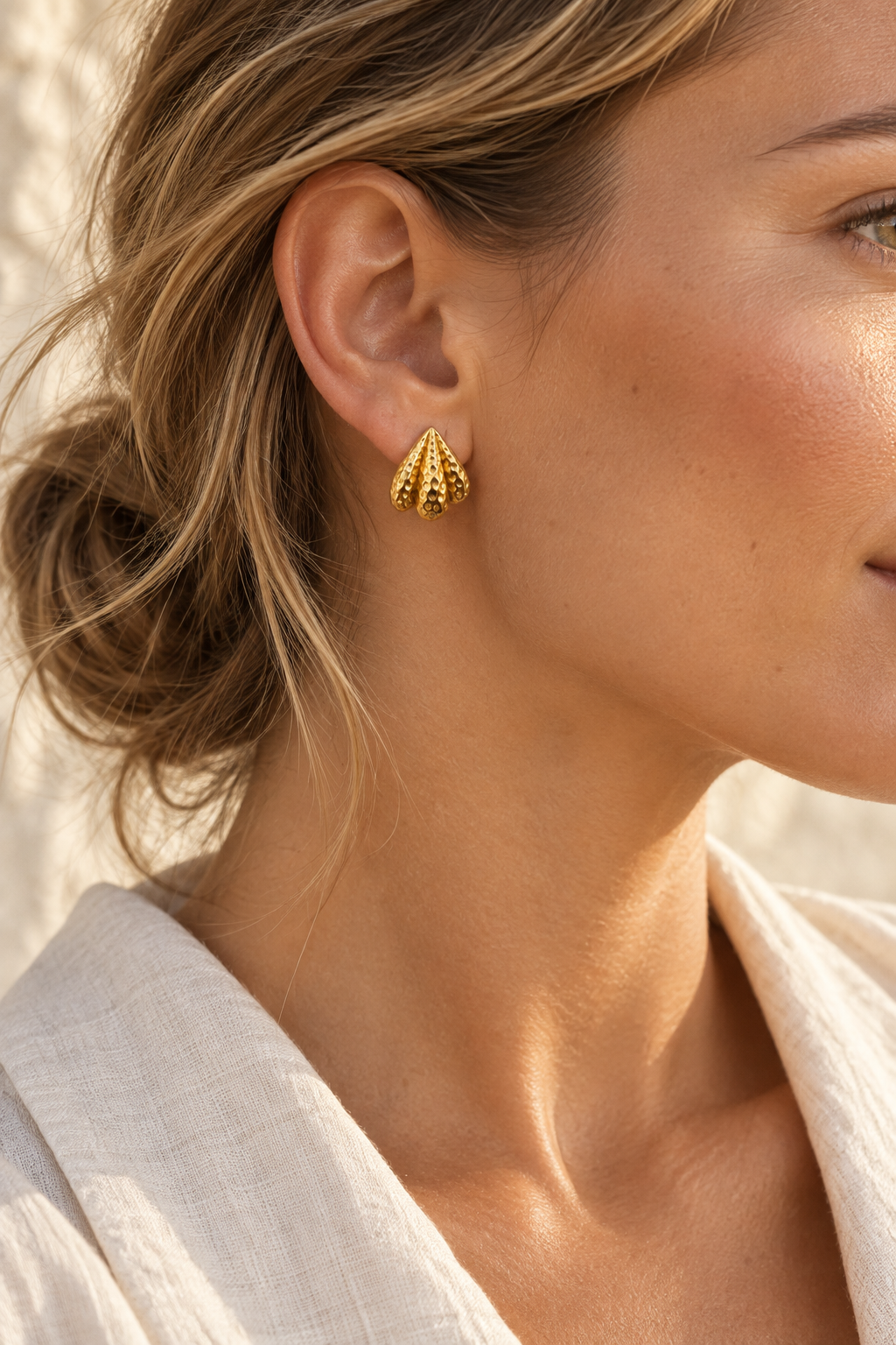 
                  
                    Model wearing Nerida textured gold shell stud
                  
                