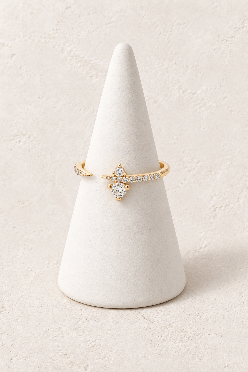 
                  
                    Nova Crystal Cluster Ring on a white display cone against a warm textured background
                  
                
