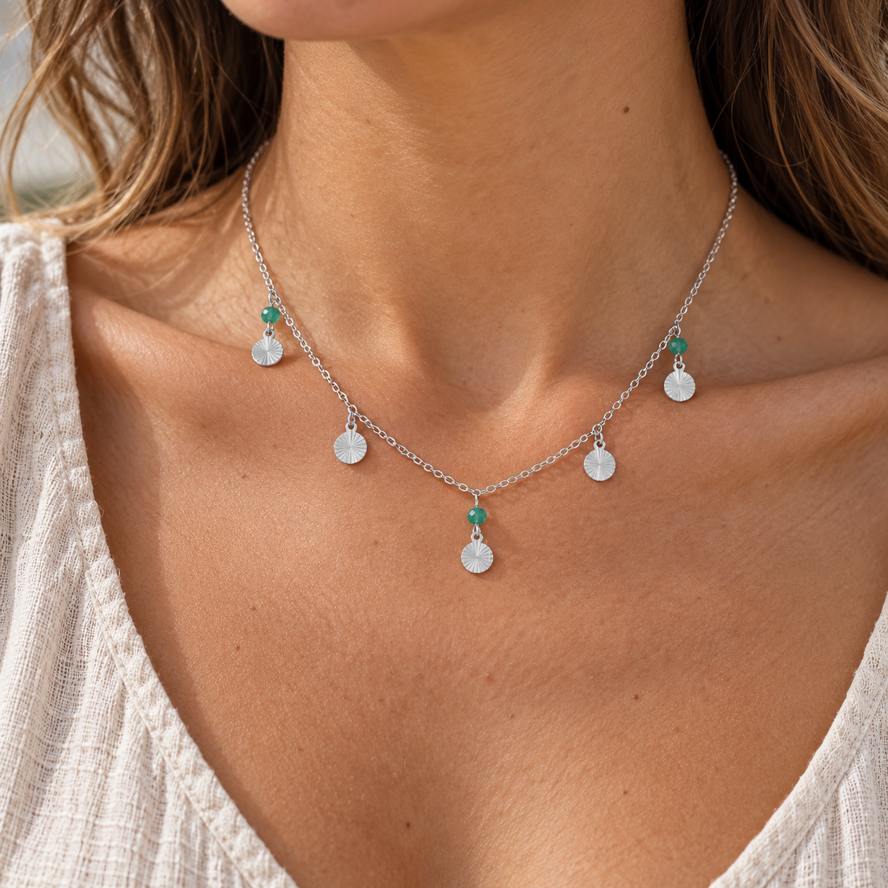 Oasis Silver Coin Drop Necklace worn on a model, showing five silver disc drops and three green beads