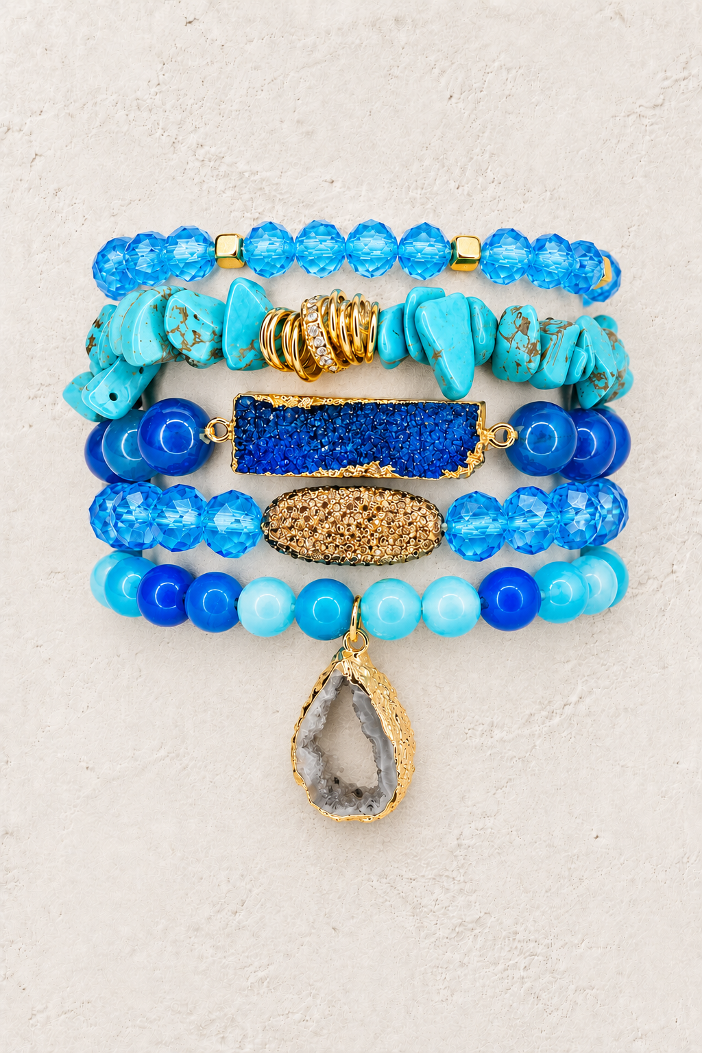 Ocean Blue 5-piece elastic bracelet stack on warm textured background