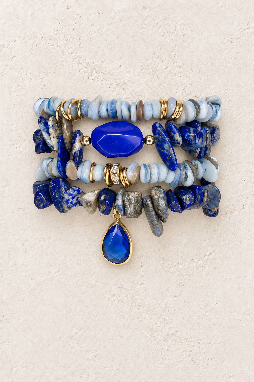 Ocean Majesty 4-piece elastic bracelet stack on warm textured background