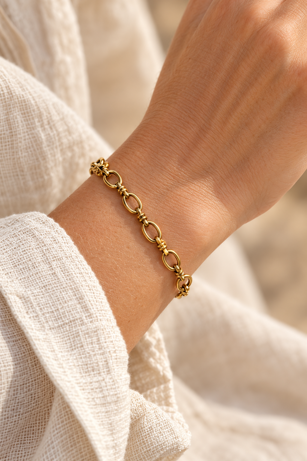 
                  
                    Ottilie Gold Oval & Collar Link Bracelet worn on a model's wrist
                  
                