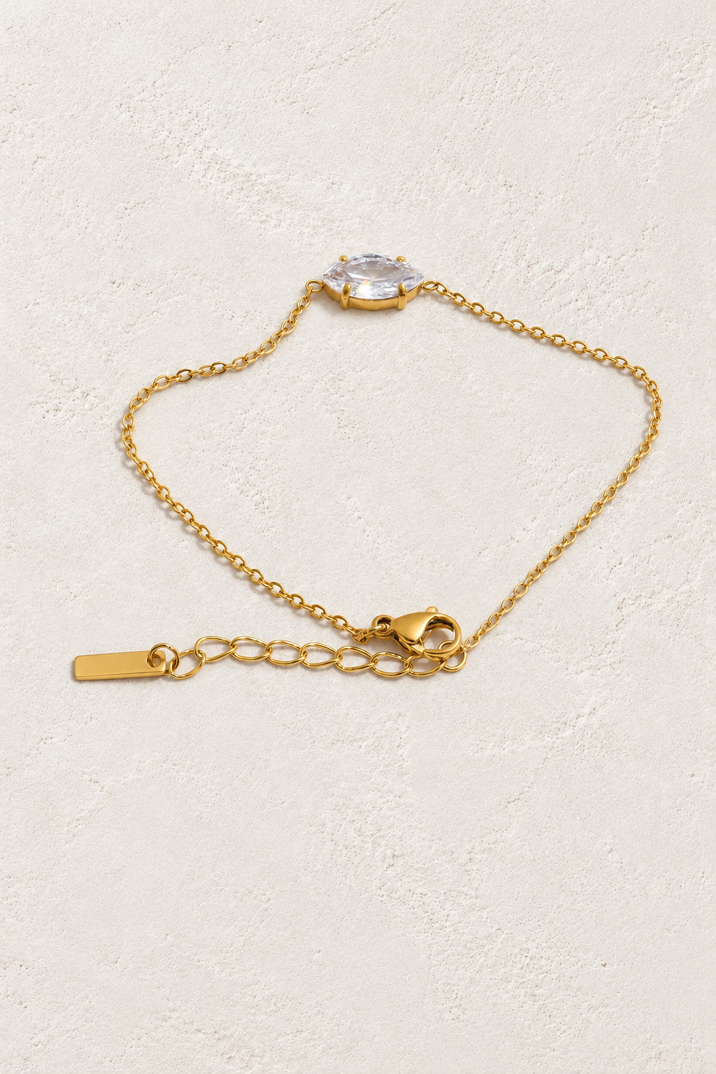 gold oval solitaire bracelet on approved cream hero background
