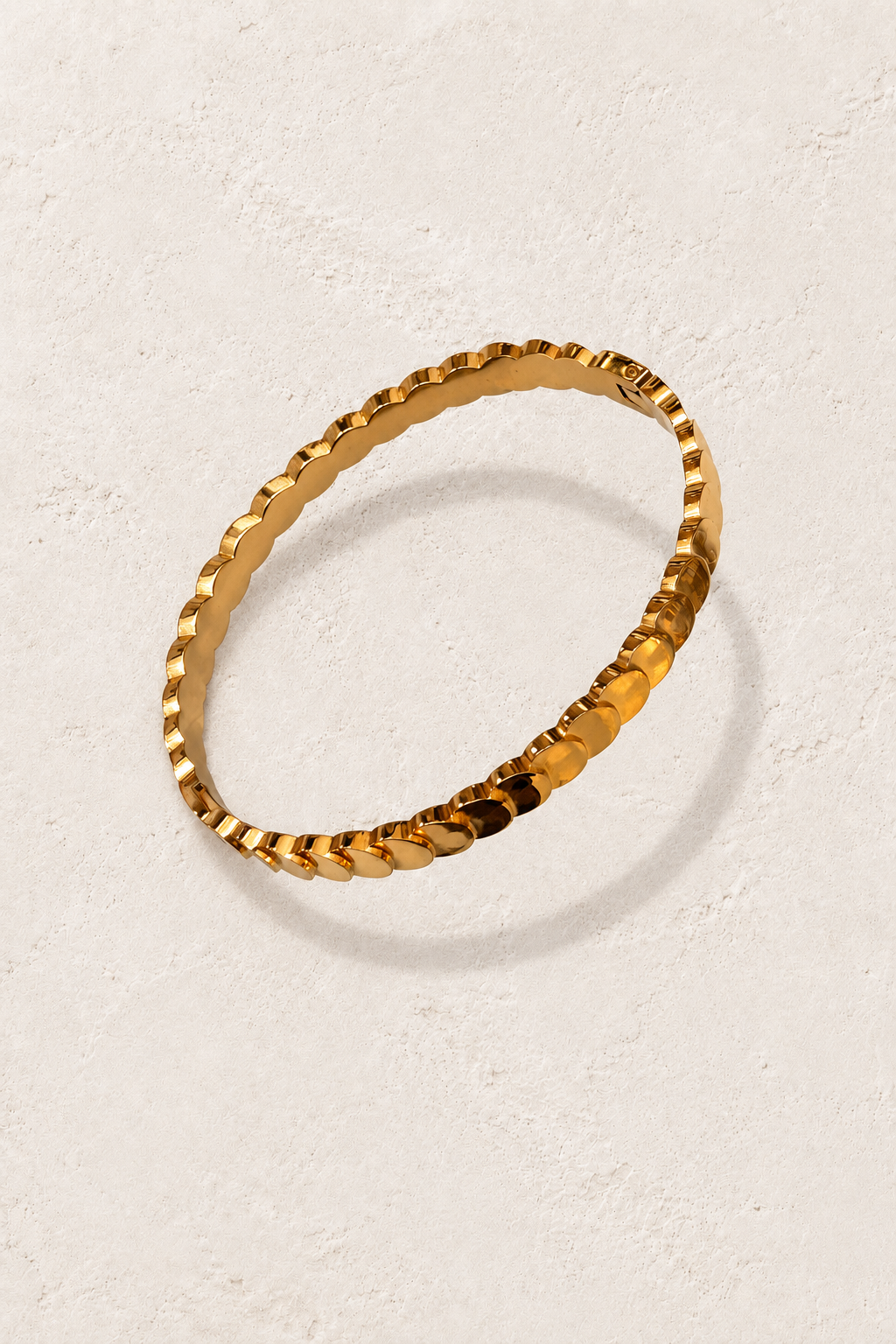 
                  
                    Paloma Gold Petal Bangle on cream beige textured background
                  
                
