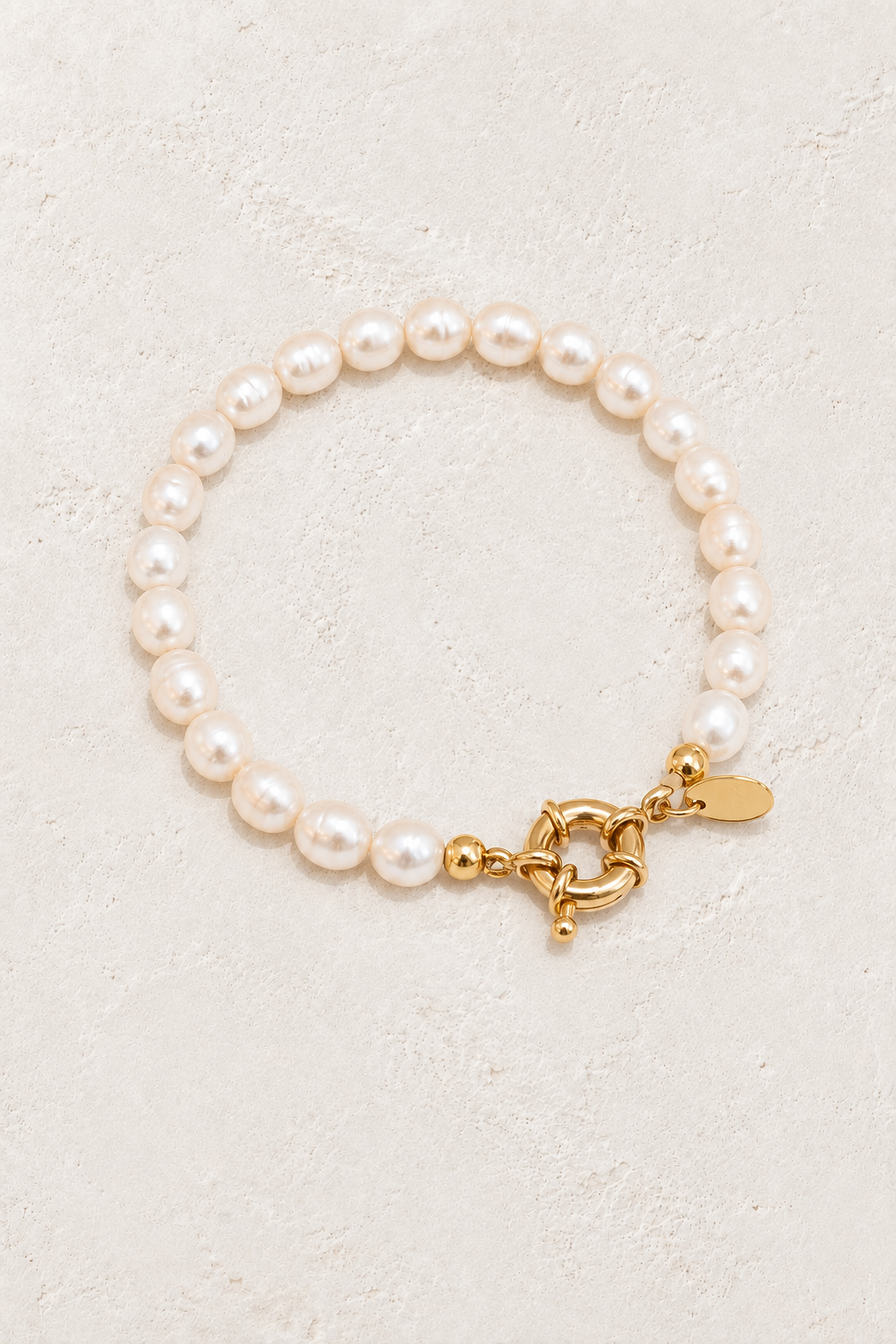 Pearl Bay freshwater pearl bracelet on a warm off-white textured plaster background