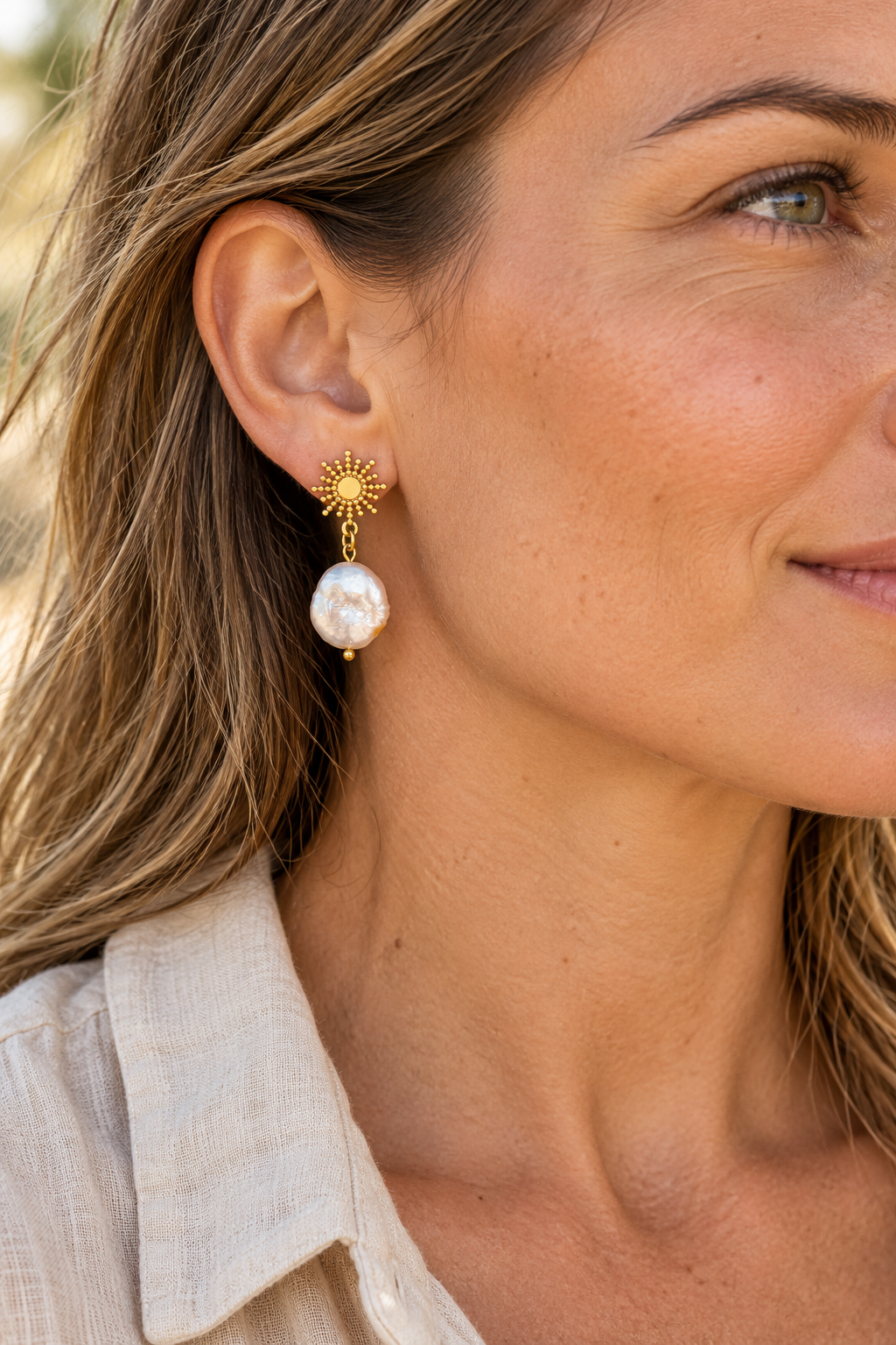 
                  
                    Gold Beaded Sunburst Coin Pearl Drop Earrings worn on a model
                  
                