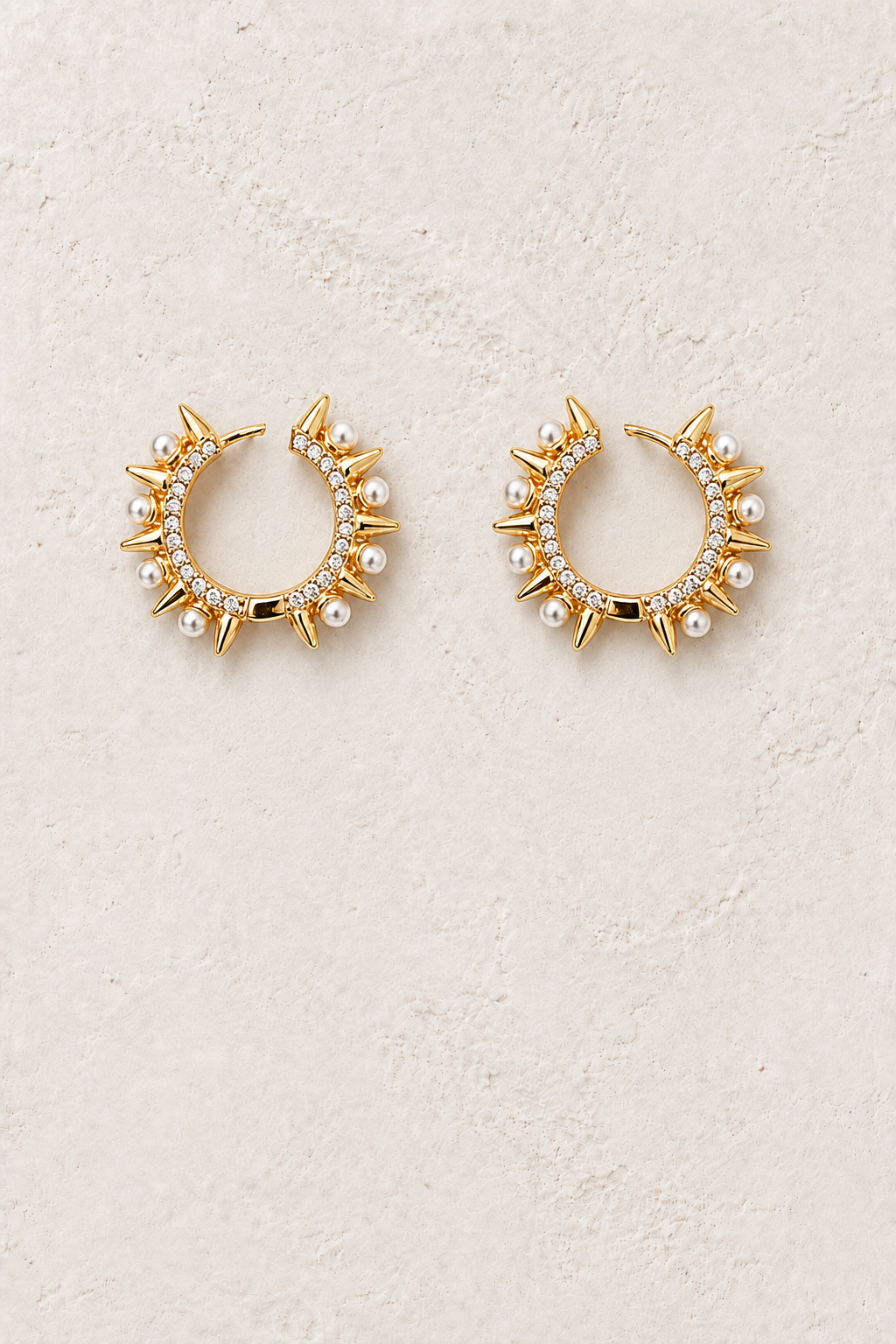
                  
                    Pearl Solstice freshwater pearl gold hoop earrings on warm textured background
                  
                