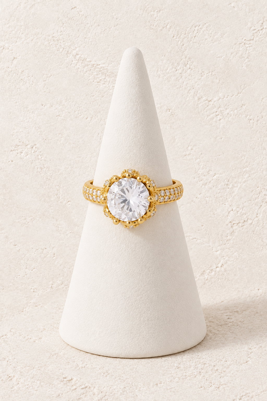 Radiant Bloom Ring on a white display cone against a warm textured background