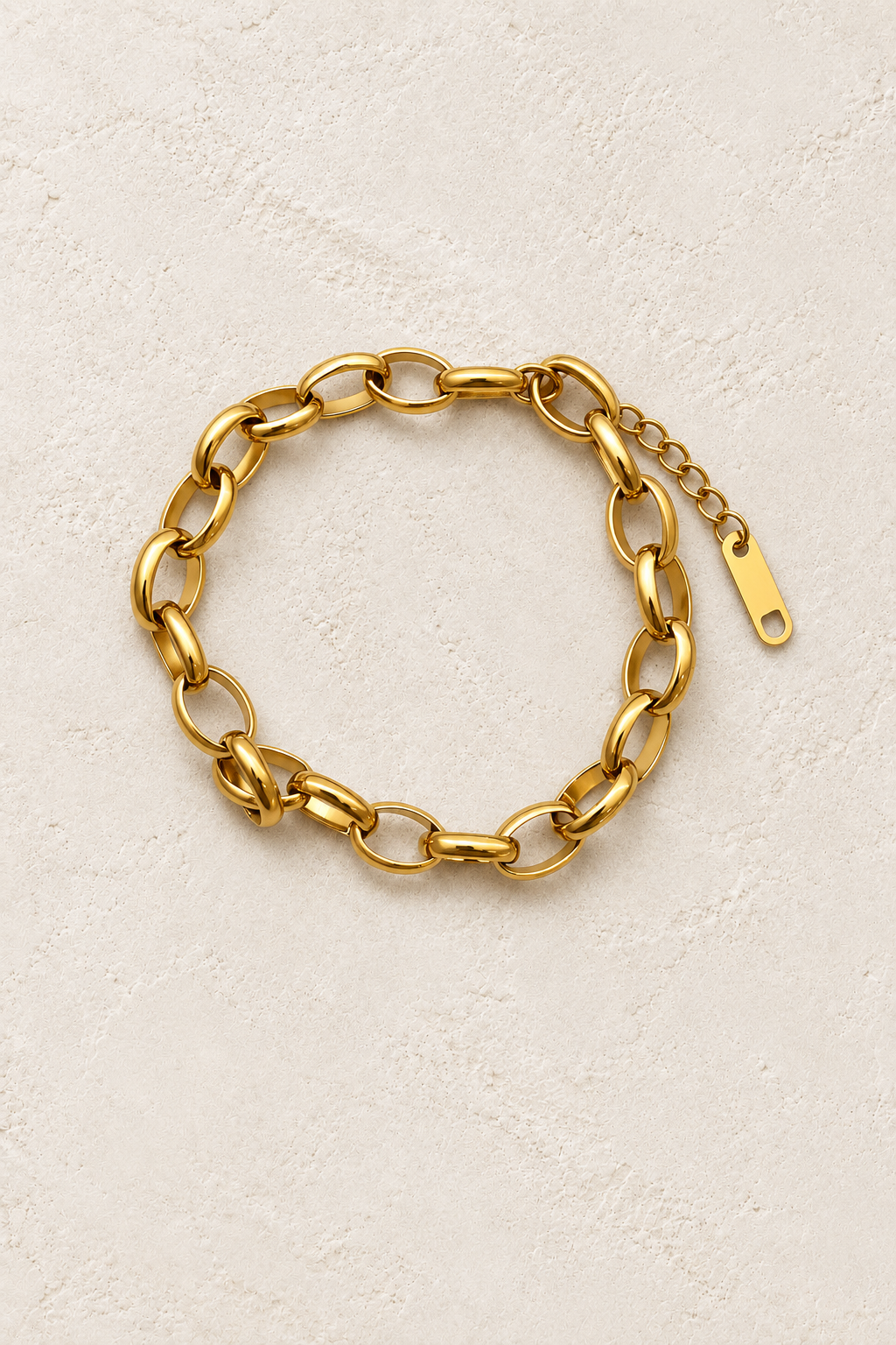 
                  
                    Romina Gold Flat Oval Link Bracelet on cream beige textured background
                  
                