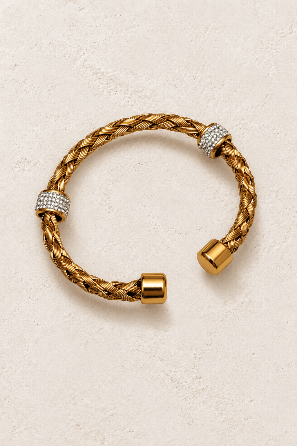 
                  
                    Safira Gold Braided Crystal Cuff on cream beige textured background
                  
                