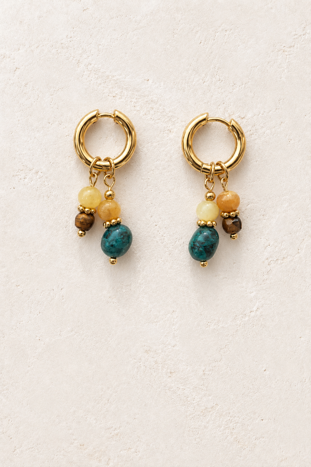 
                  
                    Savana Gold Multicolour Bead Charm Hoop Earrings on cream plaster background
                  
                