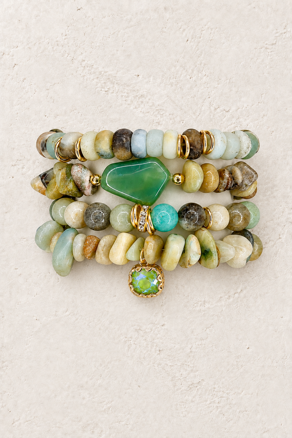 Seafoam Serenity 4-piece elastic bracelet stack on warm textured background