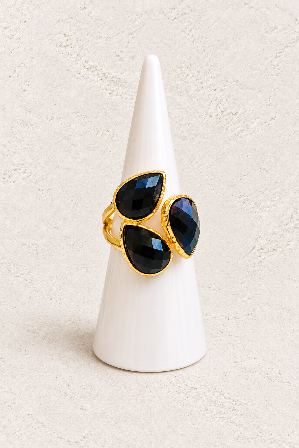 Seraphine Black Obsidian Ring on white cone against warm textured background