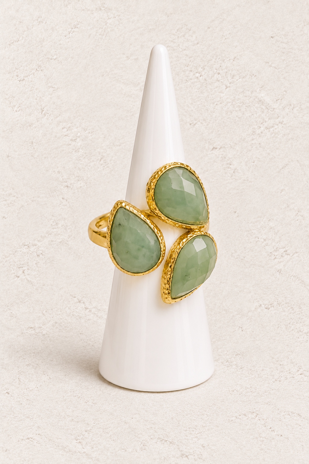 Seraphine Green Chalcedony Ring on white cone against warm textured background