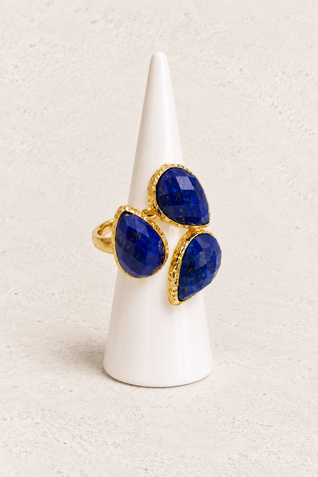 Seraphine Lapis Lazuli Ring on white cone against warm textured background