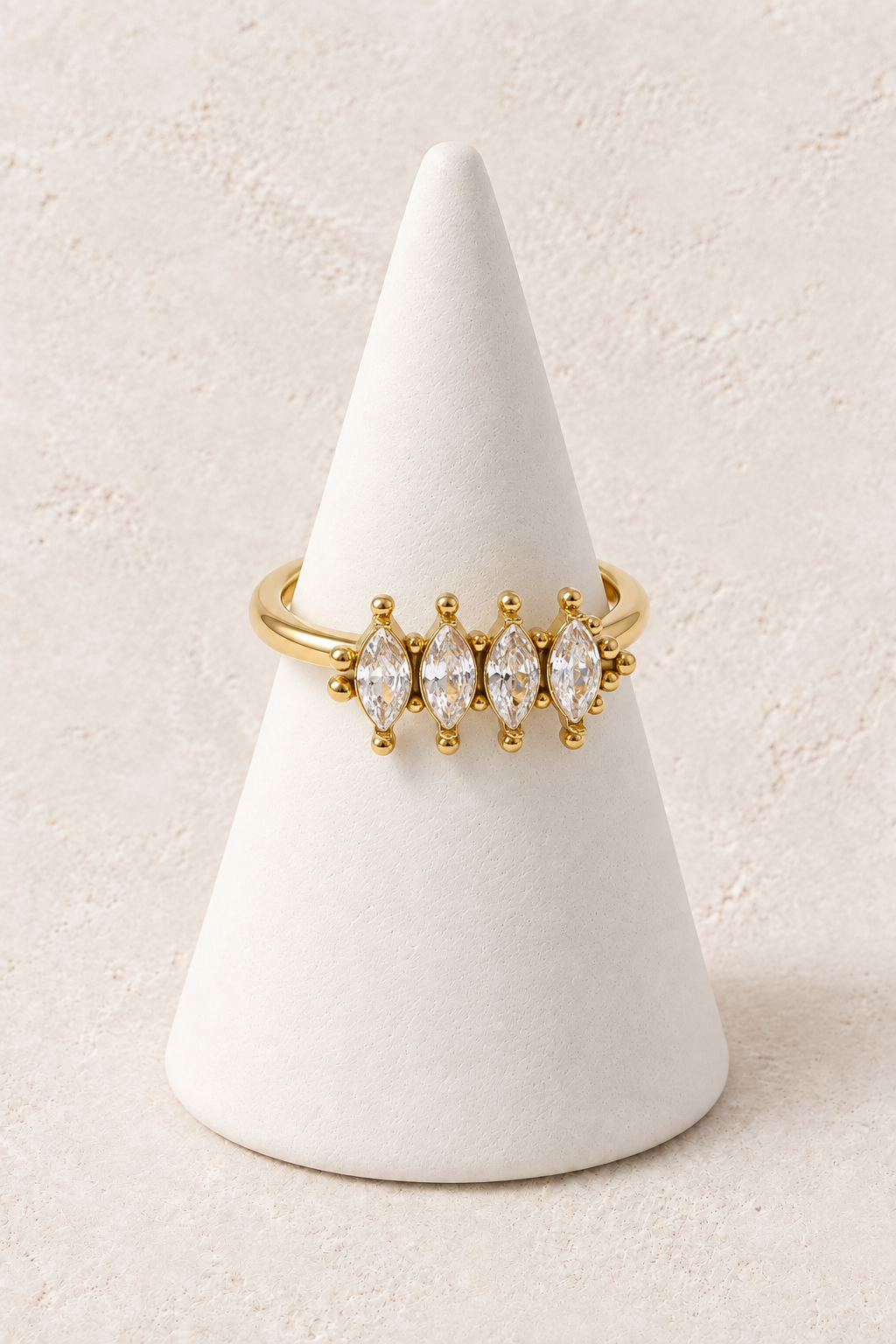 Seraya Marquise Crystal Ring on an ivory cone against warm textured plaster