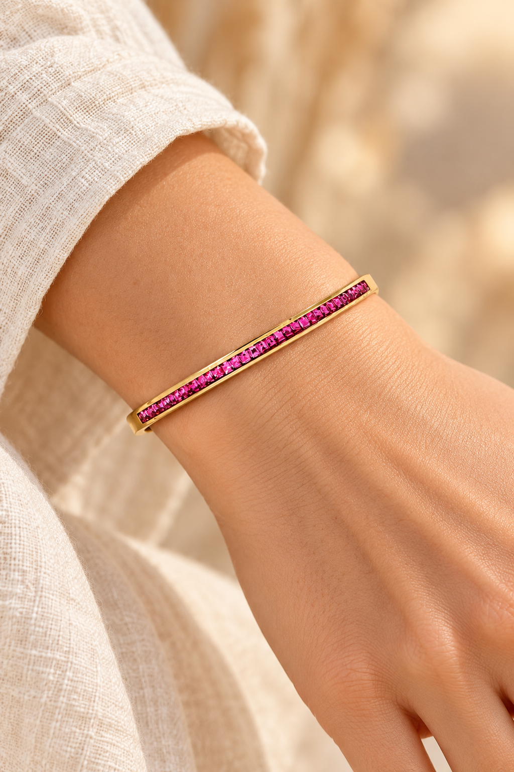 
                  
                    Serene Gold Pink Crystal Bangle worn on a model's wrist
                  
                