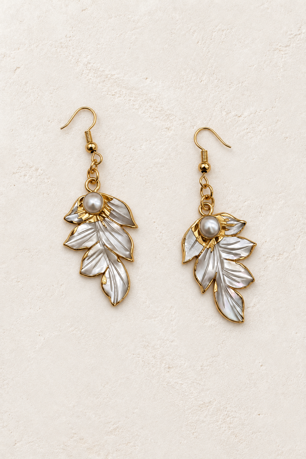 Shell Drop Feather Earring on cream textured background