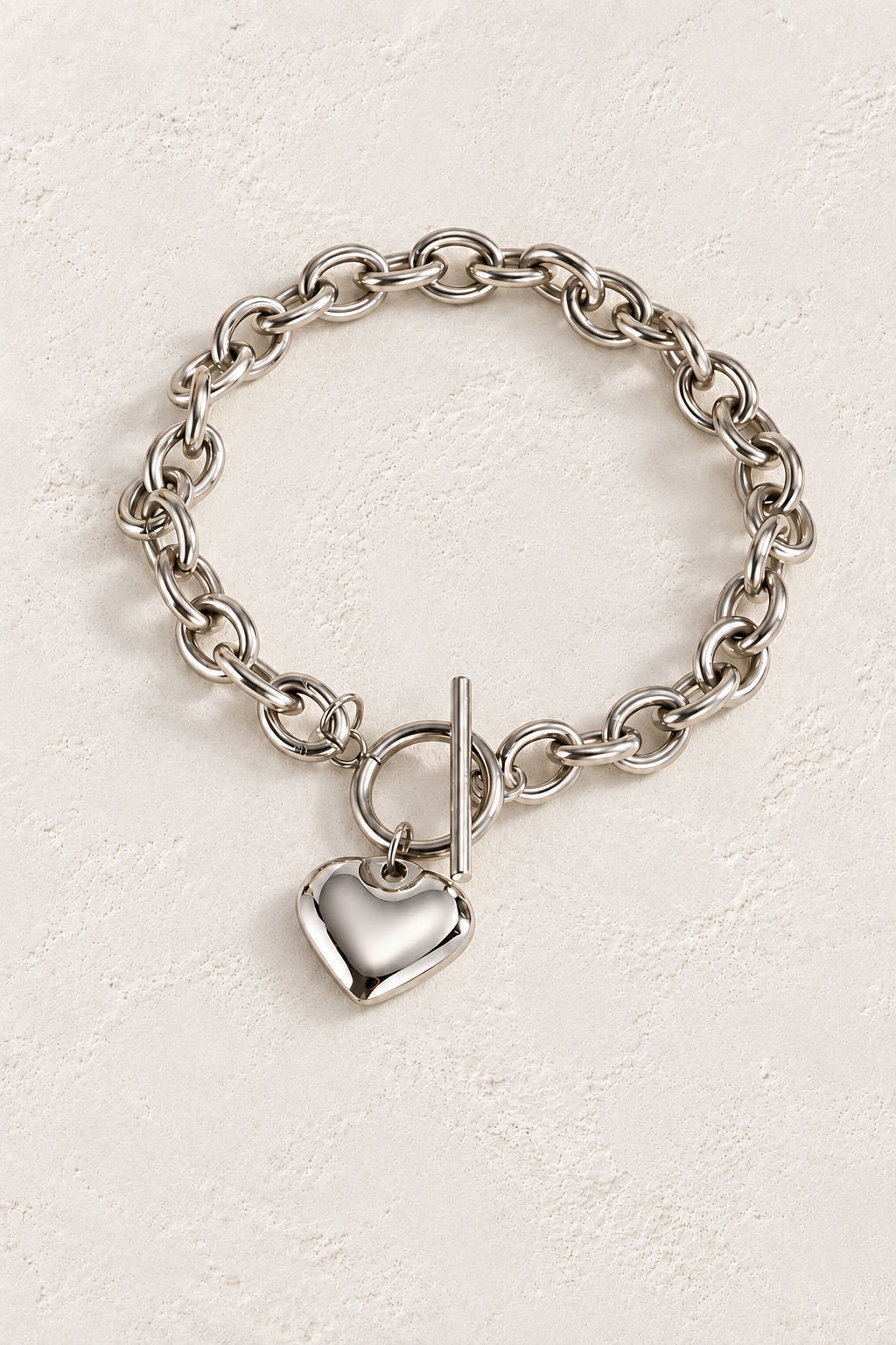 
                  
                    Silver Heart Toggle Bracelet | Waterproof on warm ivory plaster background
                  
                