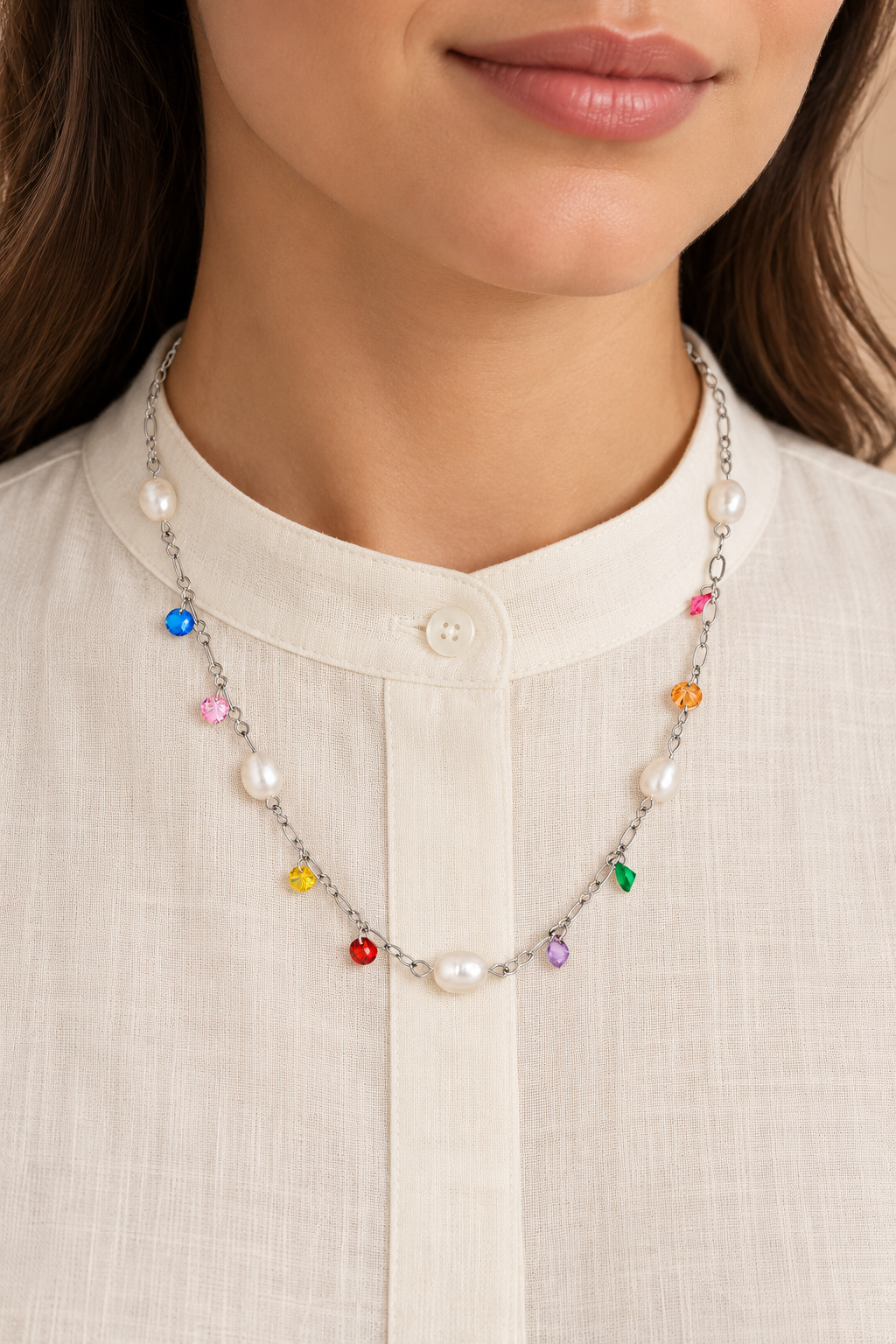 
                  
                    Silver pearl and colourful crystal necklace worn on a model over an ivory shirt
                  
                