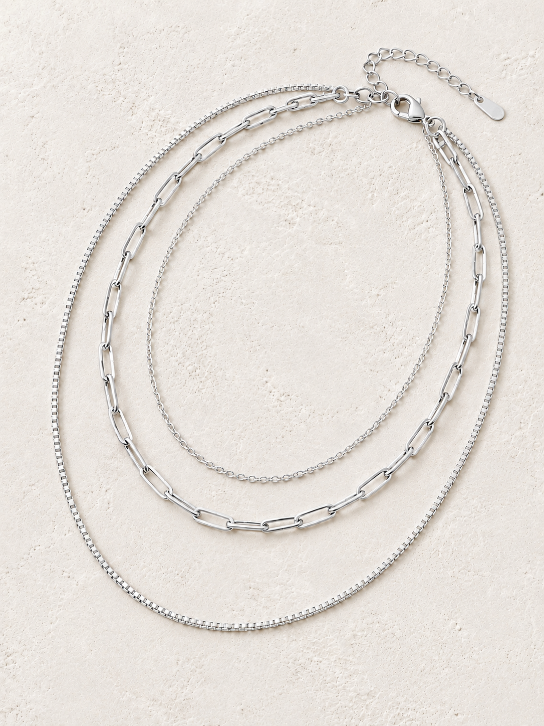 Capri Silver Triple Layer Chain Necklace on the Boho & Mala cream stone hero background