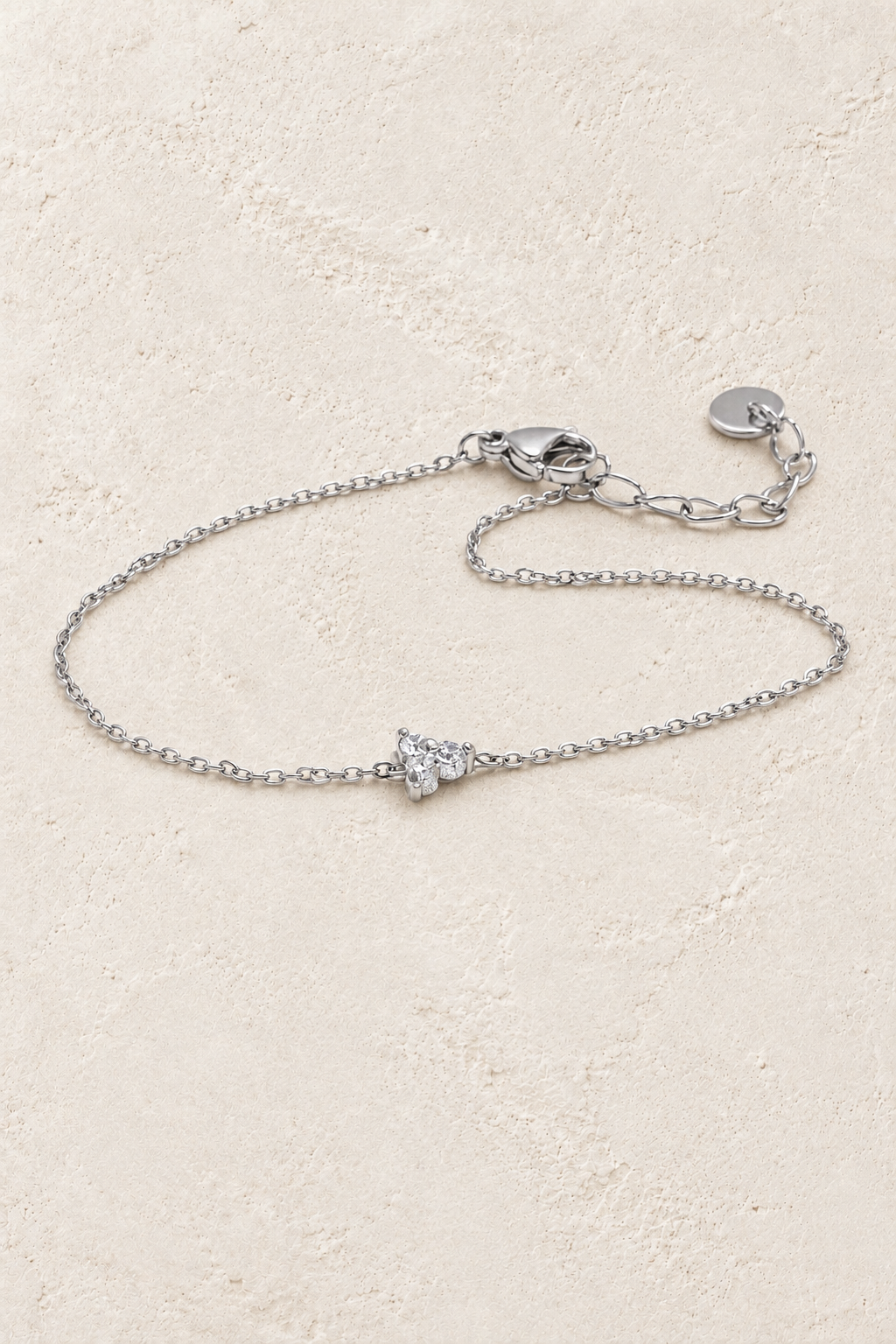 Silver crystal butterfly chain bracelet on approved ivory stone background