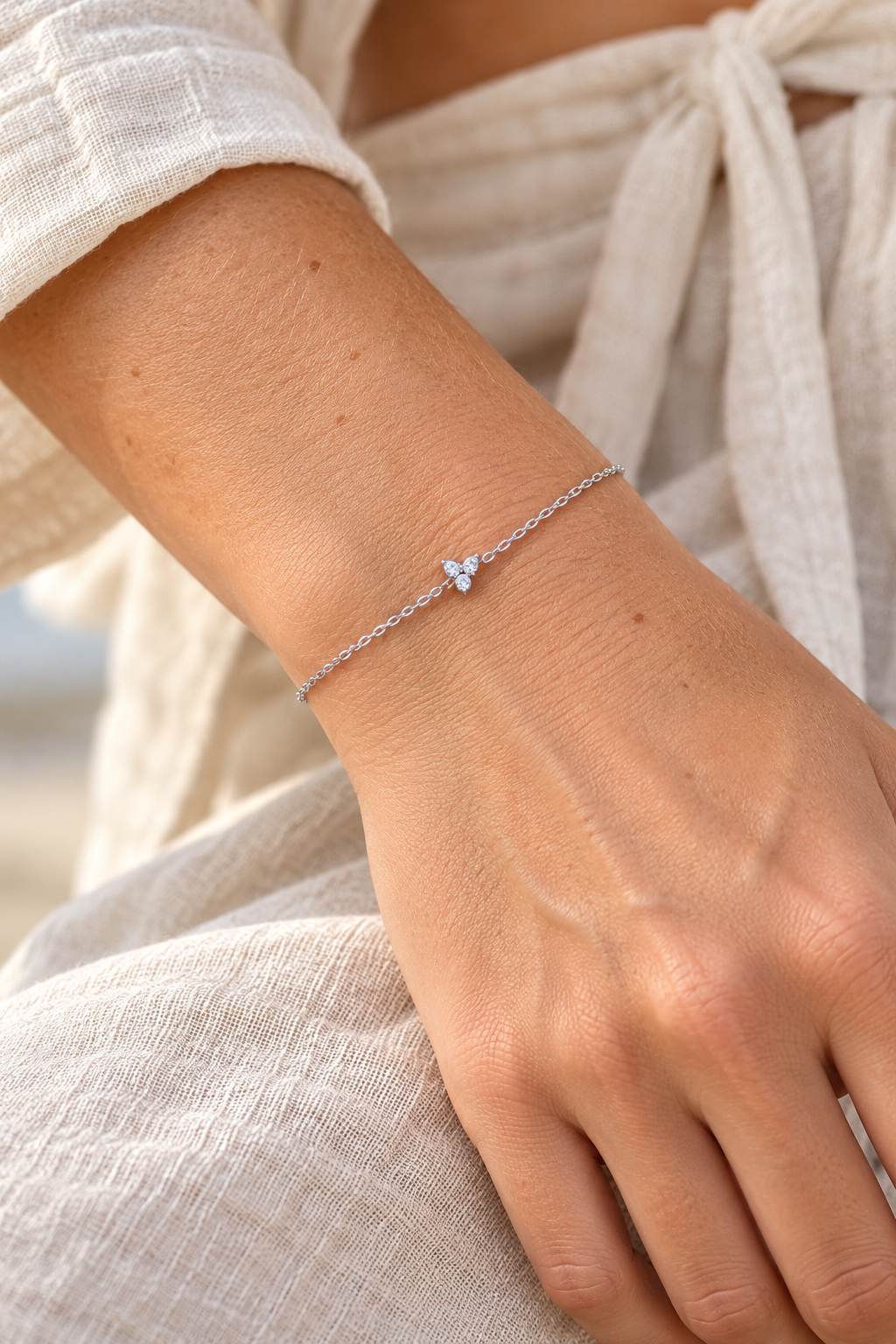 Silver crystal butterfly chain bracelet worn on a wrist