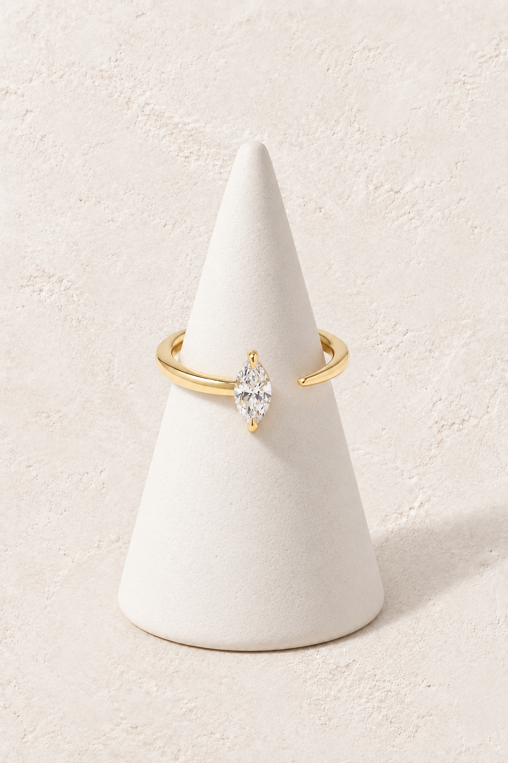 
                  
                    Soleia Marquise Crystal Ring on a white display cone against a warm textured background
                  
                