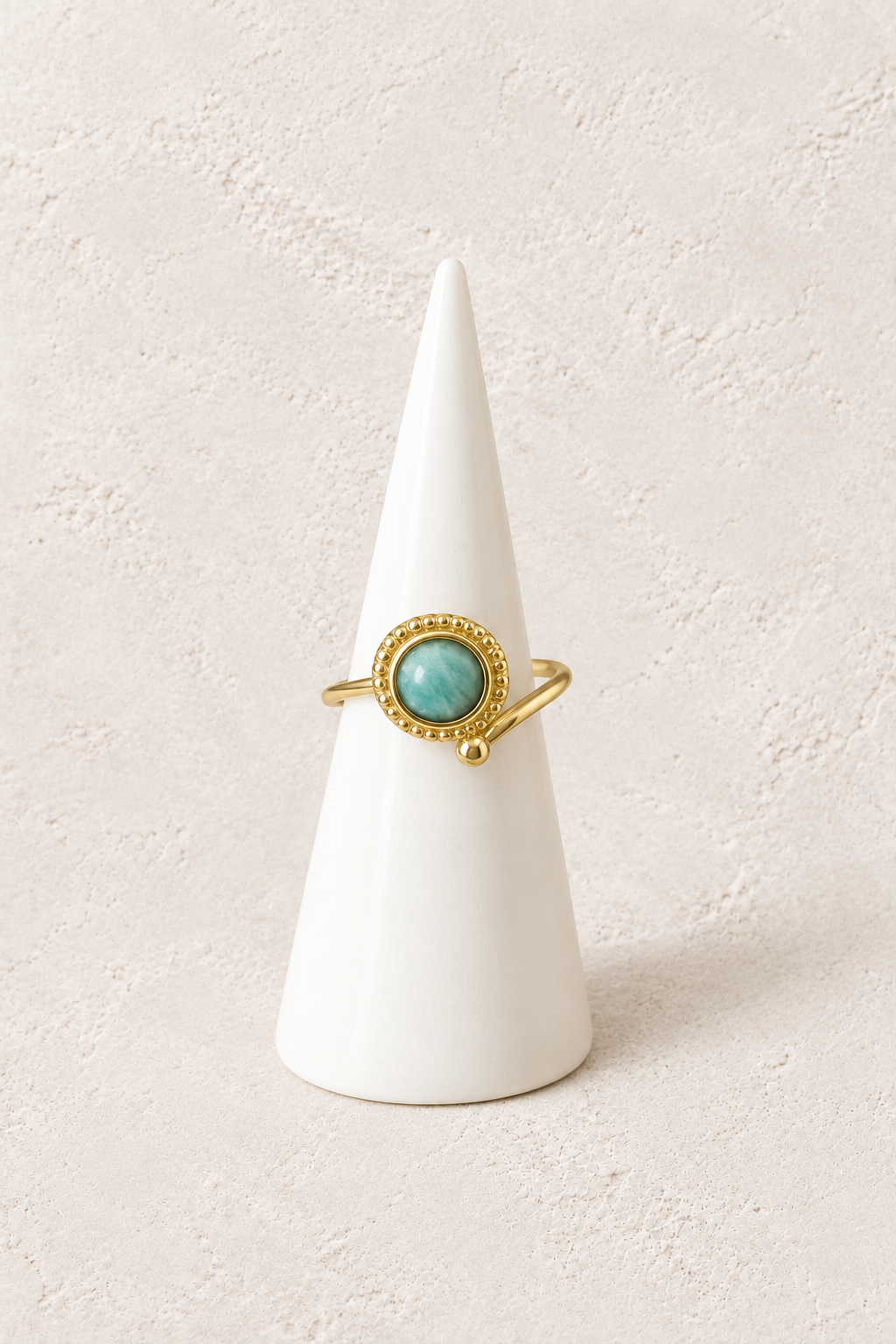 Soleya Amazonite Rope Ring on a white display cone against a warm textured background