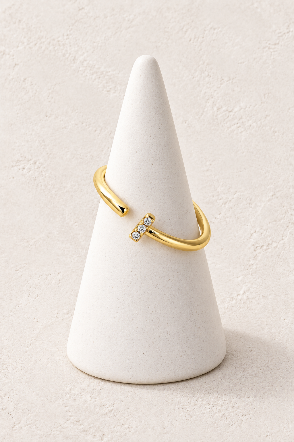 
                  
                    Solis Crystal Bar Ring on a white display cone against a warm textured background
                  
                