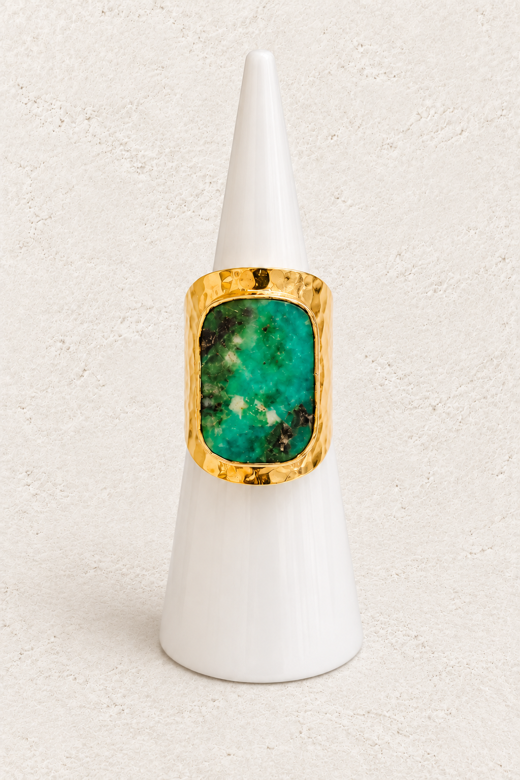 Soraya Chrysoprase Ring on white cone against warm textured background