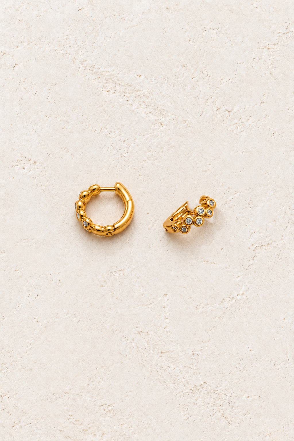Sorelle Bezel Huggies - 18K Gold Plated Sterling Silver on warm ivory textured background