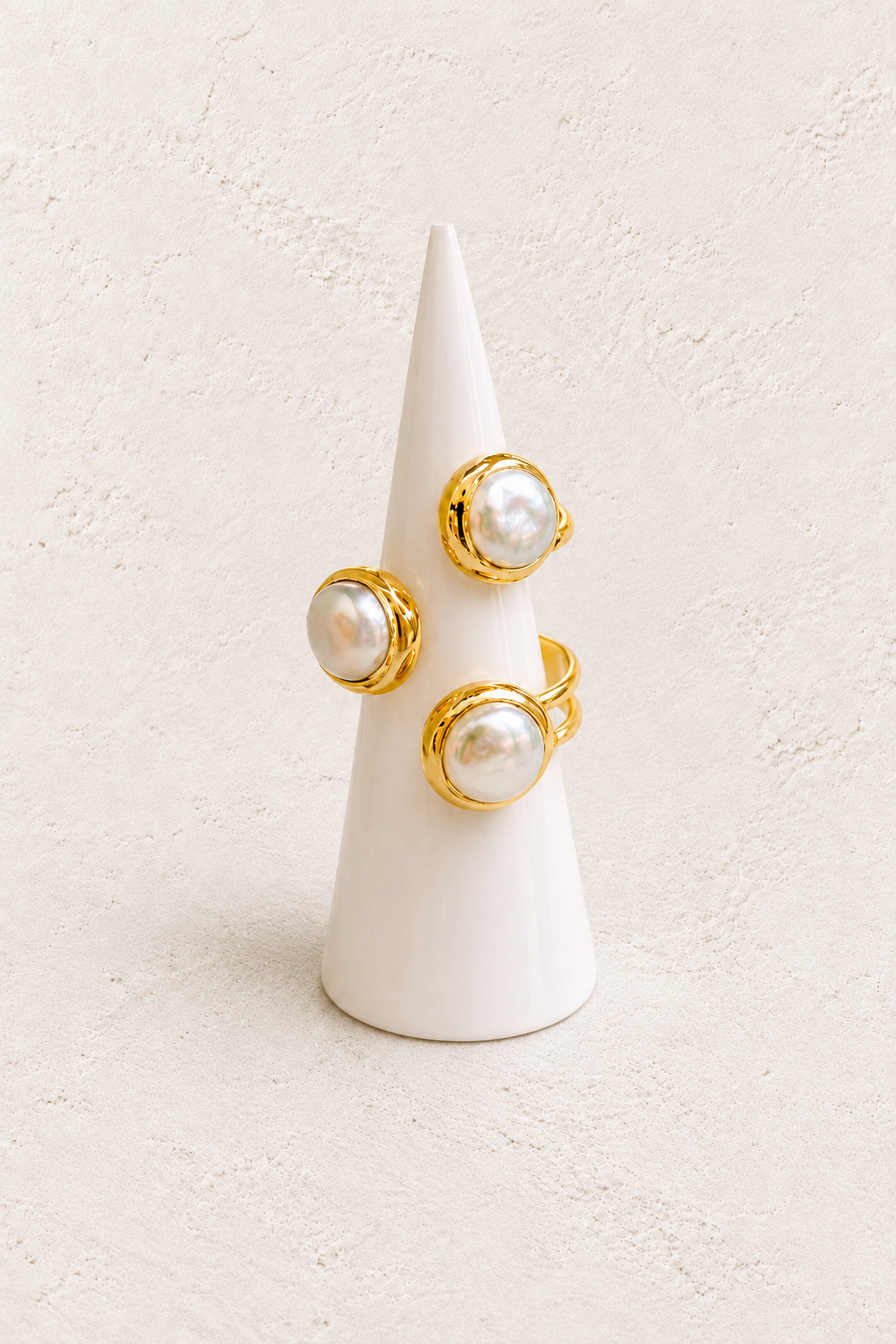Sorelle Freshwater Pearl Ring (Adjustable) on white cone against warm textured background