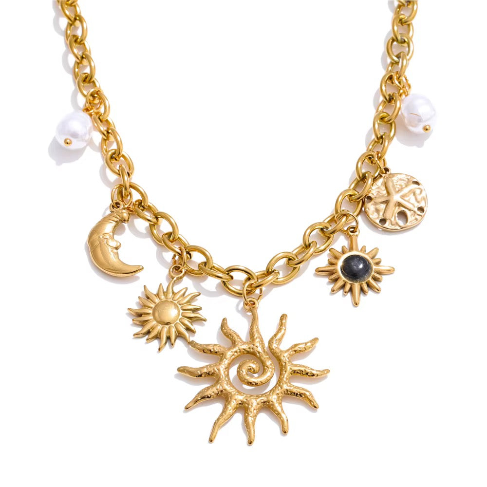 
                  
                    Gold celestial charm necklace with spiral sun, crescent moon and imitation pearls
                  
                