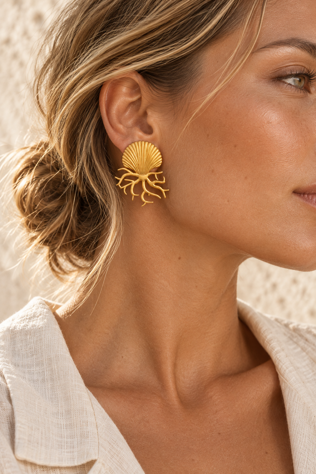 Model wearing Sundara gold coral shell stud earring