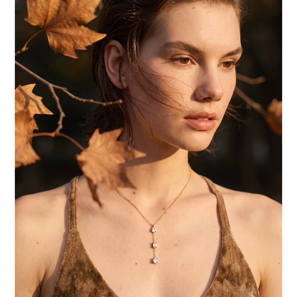 
                  
                    Gold three crystal lariat necklace worn on model
                  
                