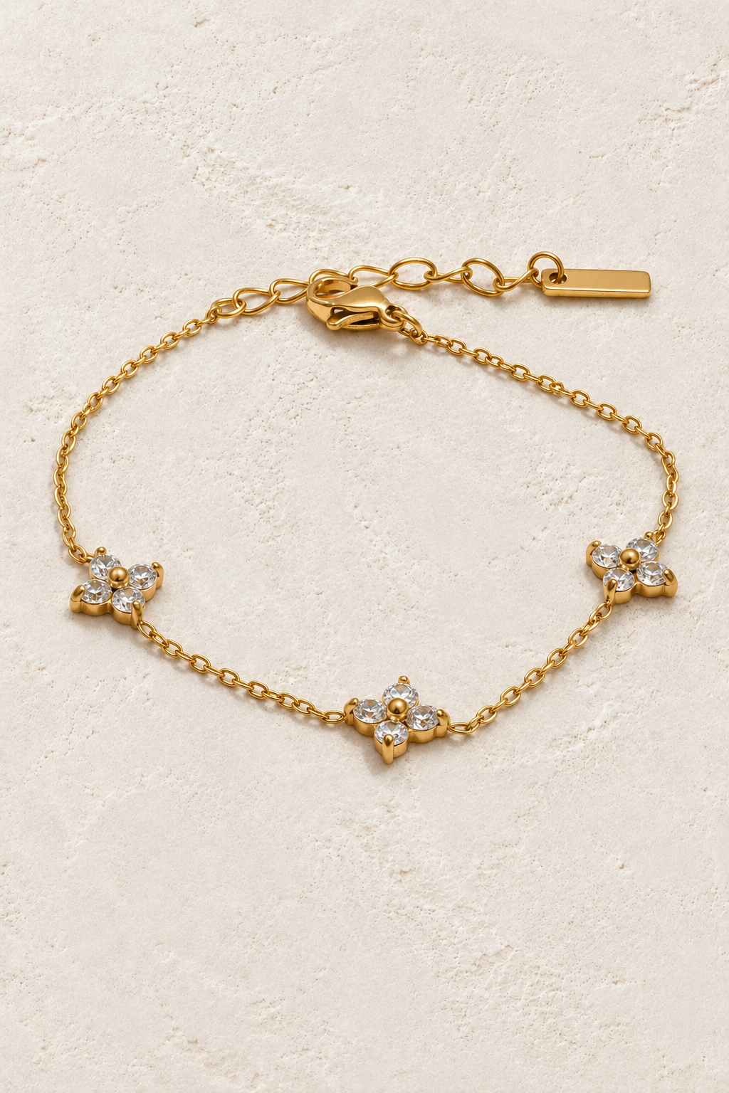 Gold triple crystal flower bracelet on ivory stone