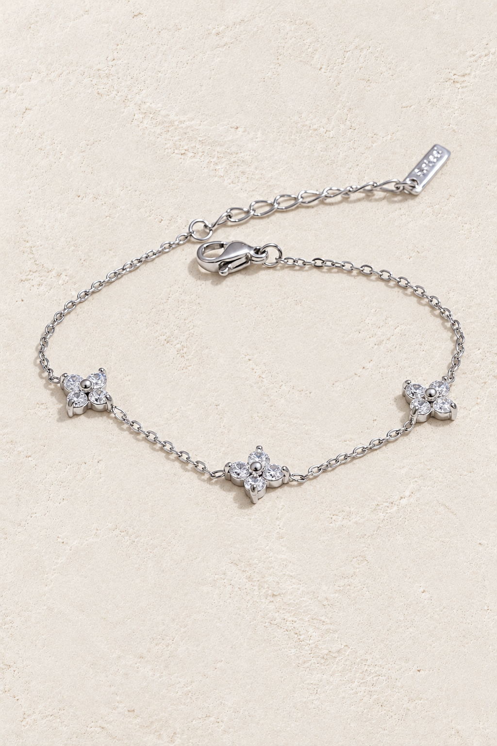 Silver triple crystal flower bracelet on ivory stone