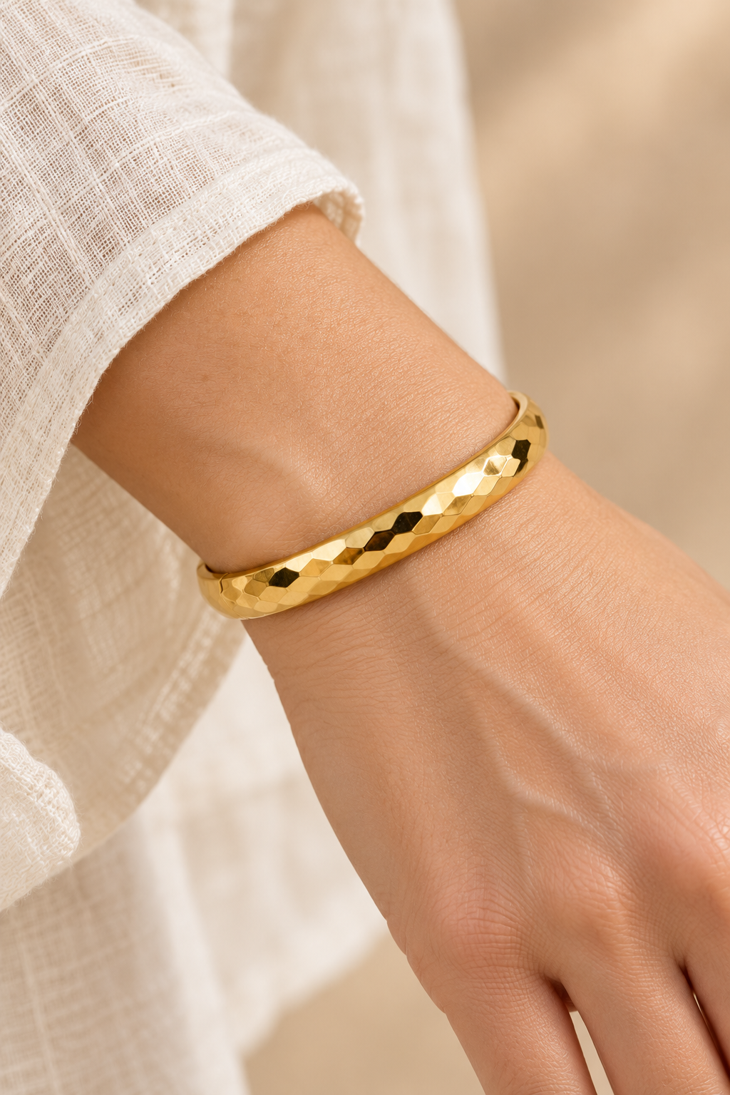 Valenza Hammered Gold Bangle worn on a model's wrist