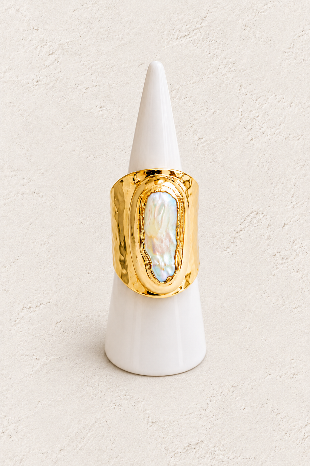 Ondelle Biwa Pearl Ring (Adjustable 6-9 size) on white cone against warm textured background