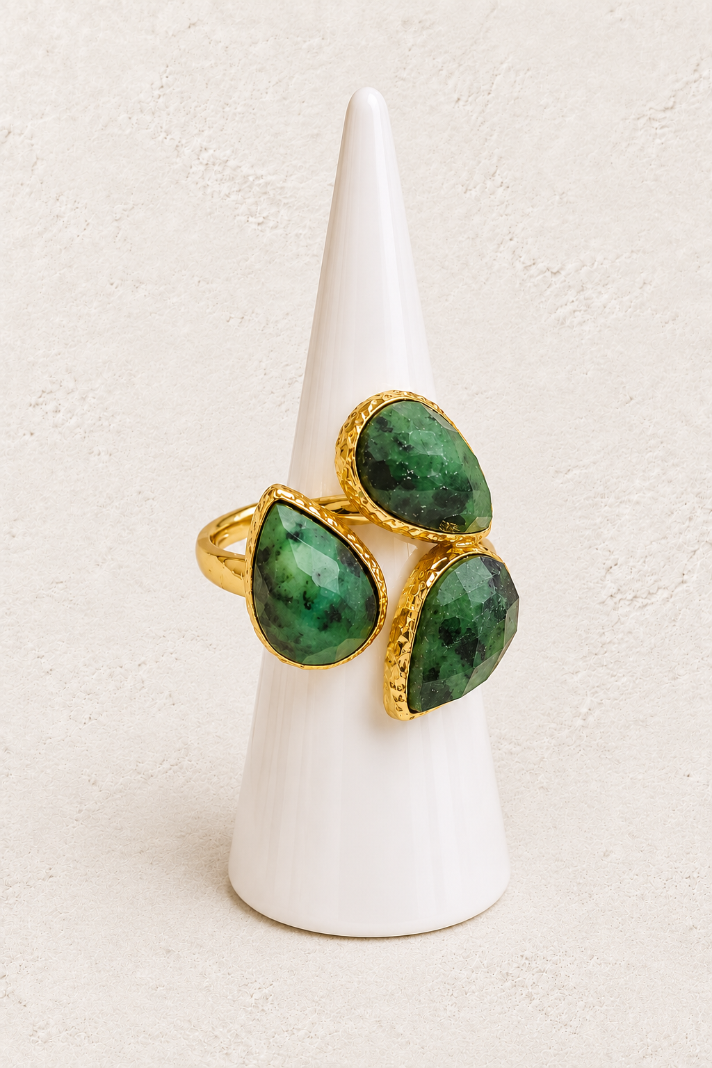 Seraphine African Turquoise Ring on white cone against warm textured background