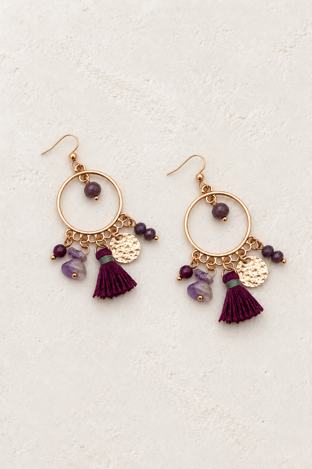 Zahara Amethyst Tassel Hoop Earrings on cream textured background