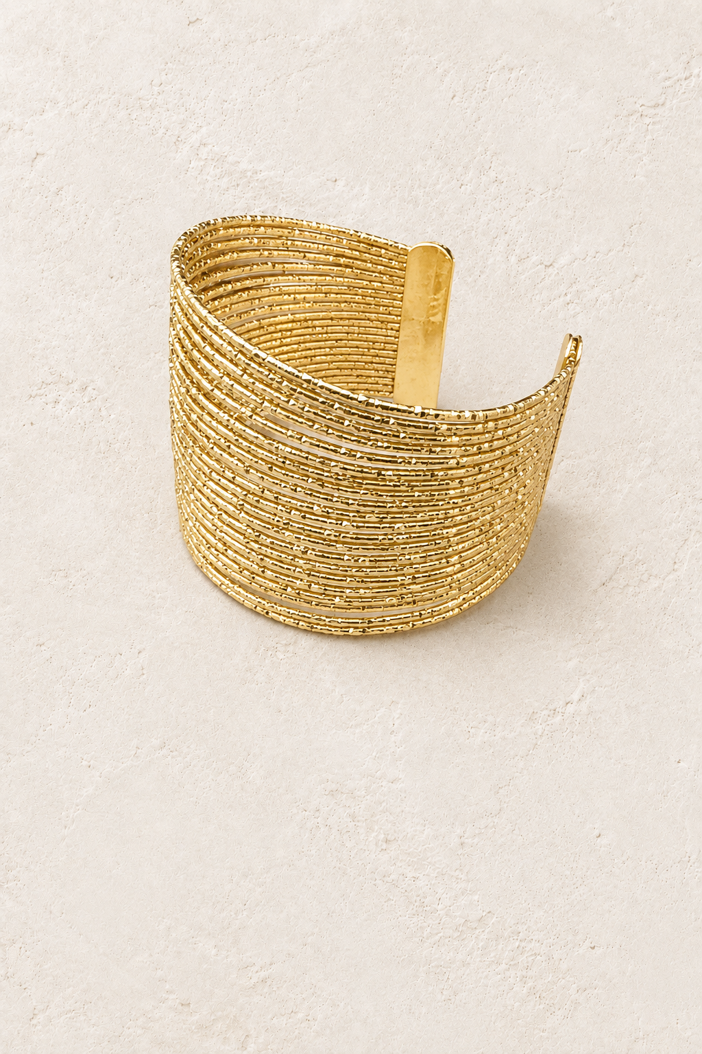 
                  
                    Zahara Multi-Strand Cuff on cream beige textured background
                  
                